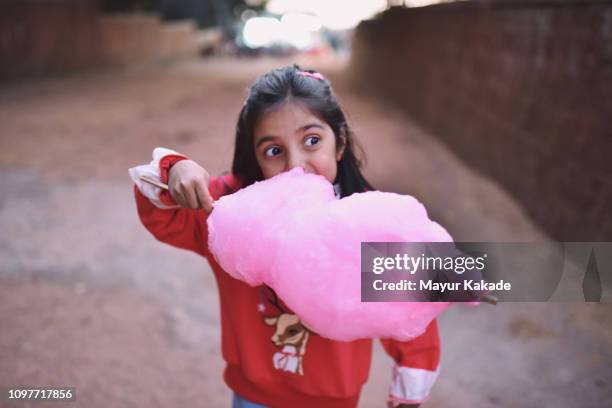 young girl (4-5 years) eating cotton candy - candyfloss stock pictures, royalty-free photos & images