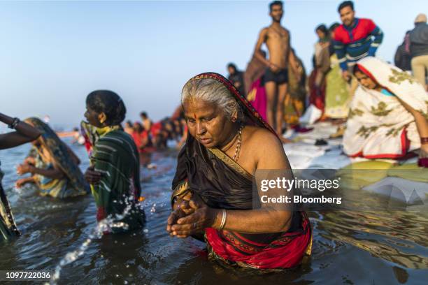 Pilgrims bathe at the ritual bathing site known as the Sangam, which is located at the confluence of three holy rivers the Ganges, the Yamuna and the...