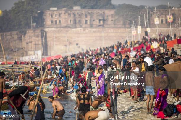 Pilgrims gather at the ritual bathing site known as the Sangam, which is located at the confluence of three holy rivers the Ganges, the Yamuna and...