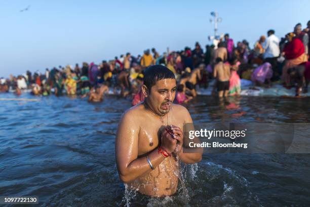 Pilgrim bathes at the ritual bathing site known as the Sangam, which is located at the confluence of three holy rivers the Ganges, the Yamuna and the...