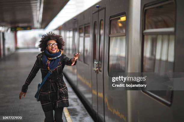 woman running to catch the train - catching stock pictures, royalty-free photos & images