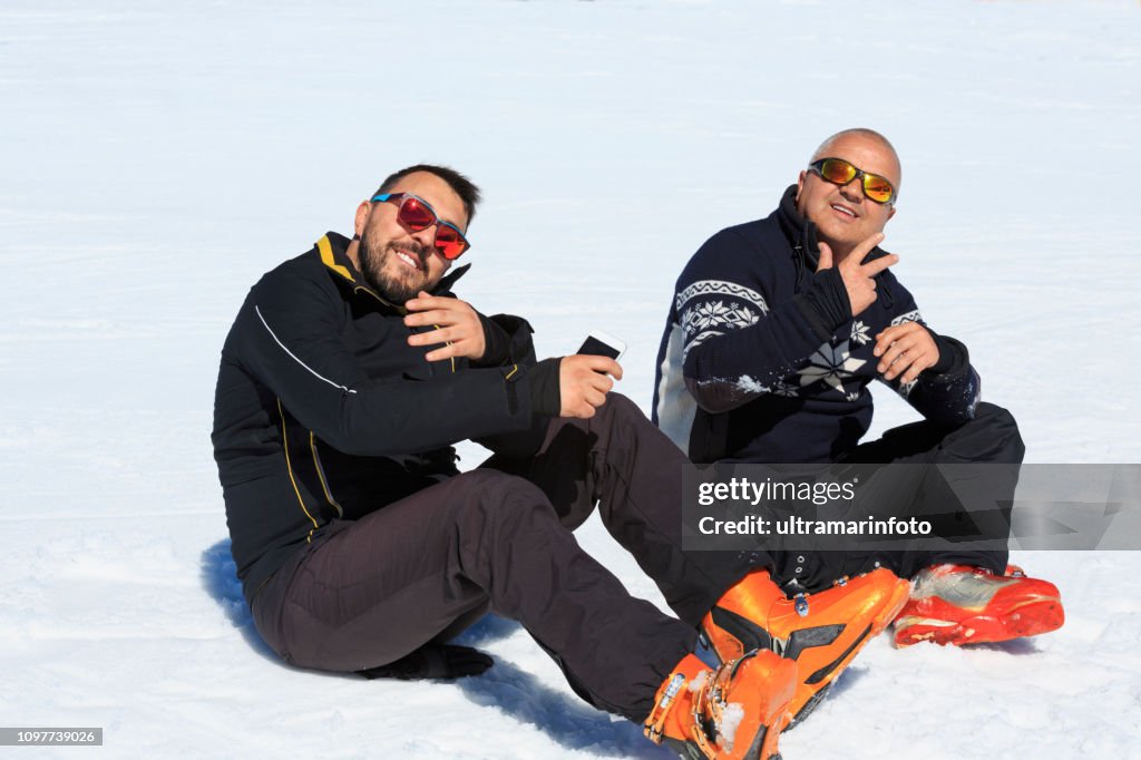 Amateur Winter Sports Group of skiers. Best friends  two men, snow skiers  enjoying on sunny ski resorts.  High mountain snowy landscape.  Kronplatz, mountain of the Dolomites in South Tyrol, Ital