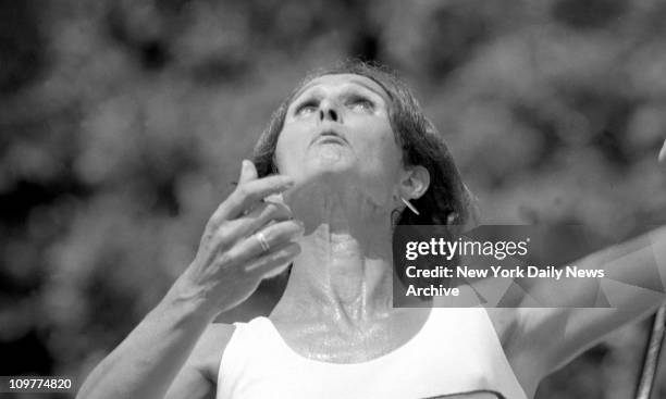 Doctor and tennis player Renee Richards, makes return, then strains to serve during a waltz with Cathy Beene at South Orange, N. J. It took the...