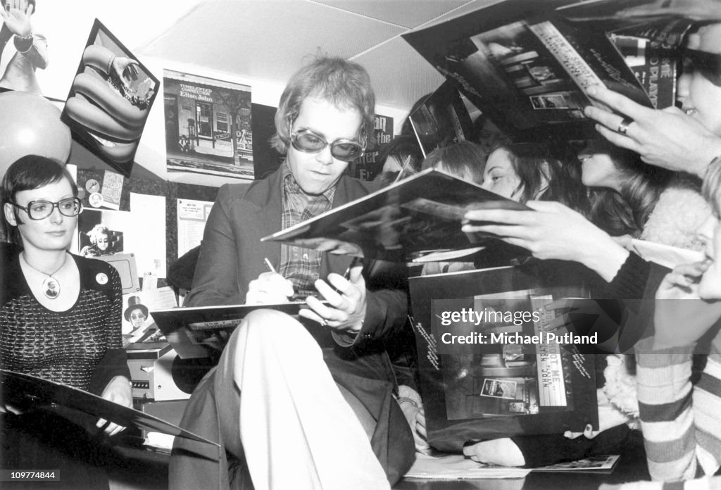 Record Signing British singer Elton John signing copies of his record 'Don't Shoot ...