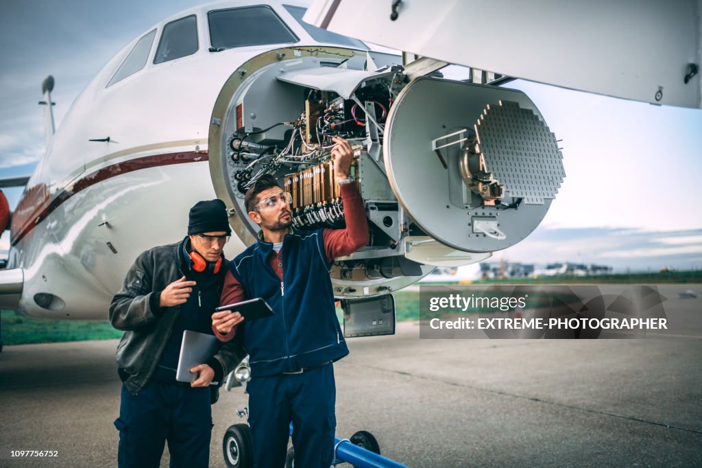 Aircraft Sensor Array Two Aircraft Engineers Fixing A Problem On A Sensor And Radar Array In ...