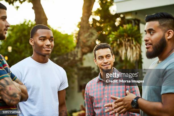 Man talking to friends in party