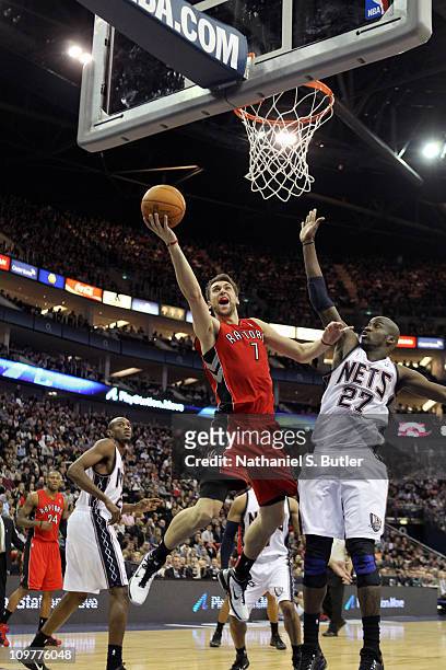 Andrea Bargnani of the Toronto Raptors shoots against Johan Petro of the New Jersey Nets during their game at the O2 Arena on March 4, 2011 in...