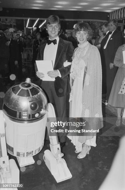 American actor Mark Hamill and his wife Marilou York with R2-D2 attend the royal premiere of 'The Empire Strikes Back' at the Odeon Leicester Square,...