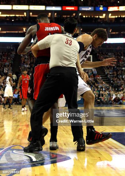 Tempers flare as Brook Lopez of the Nets and Amir Johnson of the Raptors clash during the NBA match between New Jersey Nets and the Toronto Raptors...