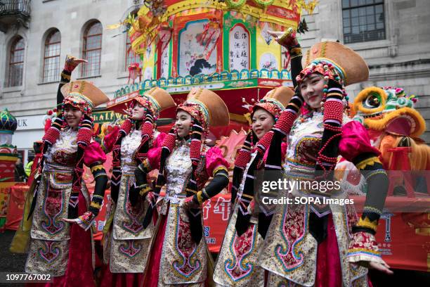 Performers at the Chinese New Year parade have some photos taken before the procession. More than 50 groups participate in the procession around the...