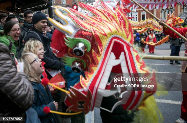 Children react excitedly to the close encounter with a Chinese dragon at the Chinese New Year parade. More than 50 groups participate in the...