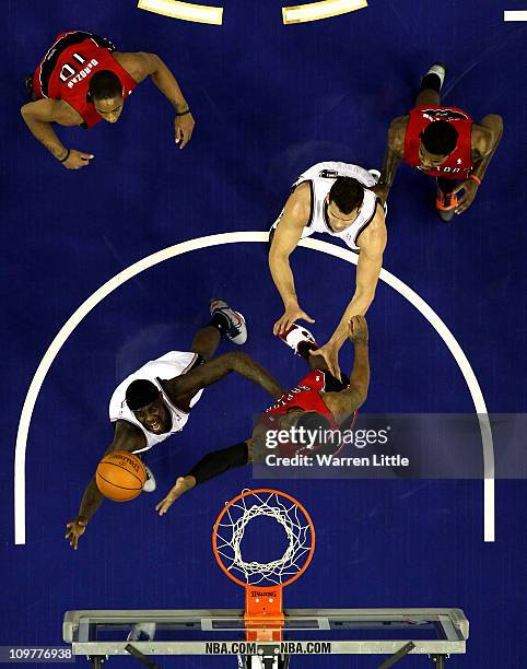 Anthony Morrow of the Nets jumps against James Johnson of the Raptors during the NBA match between New Jersey Nets and the Toronto Raptors at the O2...