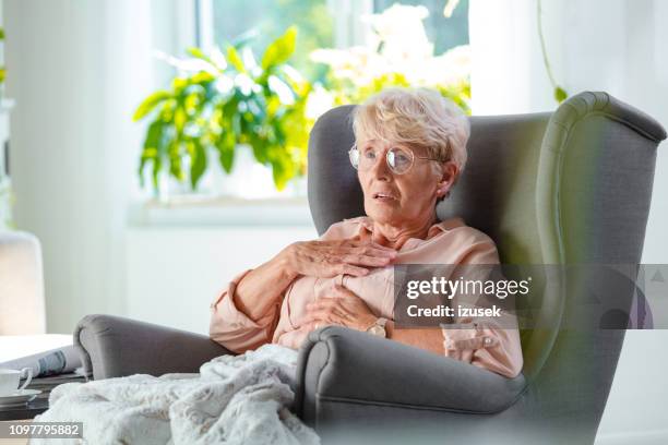 worried elderly lady having pain in chest - patient bad news stock pictures, royalty-free photos & images