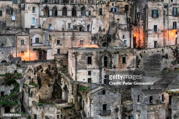 old town district at dusk, matera, basilicata, italy - cliff dwelling stock pictures, royalty-free photos & images