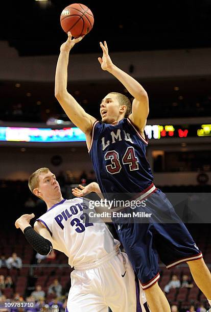 Drew Viney of the Loyola Marymount Lions shoots over Ryan Nicholas of the Portland Pilots during the first round of the Zappos.com West Coast...