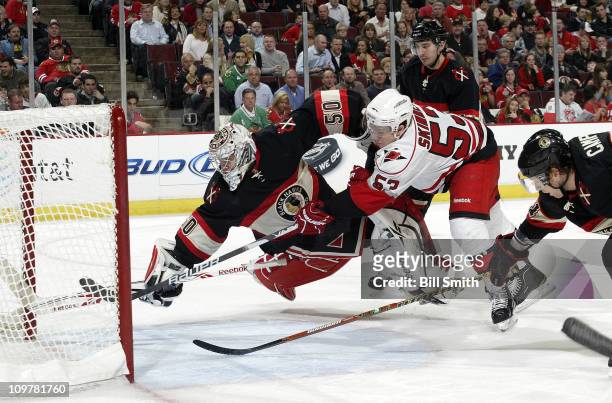 Jeff Skinner of the Carolina Hurricanes scores on goalie Corey Crawford of the Chicago Blackhawks, as Brian Campbell of the Blackhawks reaches across...