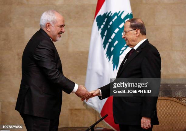 Lebanese President Michel Aoun shakes hands with Iranian Foreign Minister Mohammad Javad Zarif at the presidential palace in Baabda, east of the...