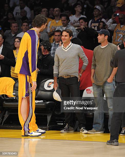 Roger Federer and Pete Sampras speak with Pau Gasol of the Los Angeles Lakers before a game between the Charlotte Bobcats and the Los Angeles Lakers...