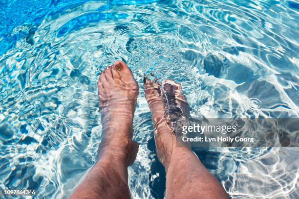 woman's feet in water in swimming pool - lyn holly coorg fotografías e imágenes de stock