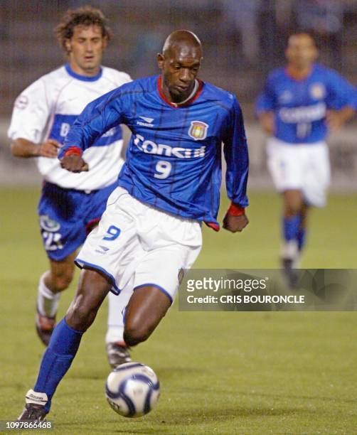 Somalia of the Sao Caetano brazilian team keeps the ball as chilean Miguel Ponc de la Universidad Catolica runs behind him during their game in...