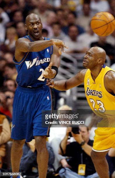 Michael Jordan of the Washington Wizards passes the ball past Mitch Richmond of the Los Angeles Lakers during first half of their 12 February 2002...