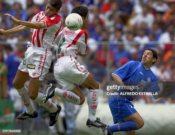 José Luis Montes de Oca and Miguel Acosta , of the Necaxa team, fight for the ball against Marinho Ledesma of the Cruz Azul, during a game in the...