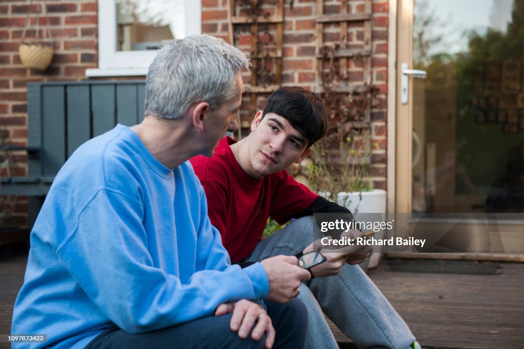 Father giving advice to teenage son.