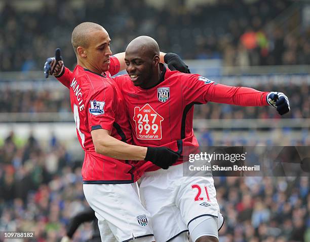 Youssuf Mulumbu of West Bromwich Albion is congratulated by team-mate Peter Odemwingie after scoring during the Barclays Premier League match between...