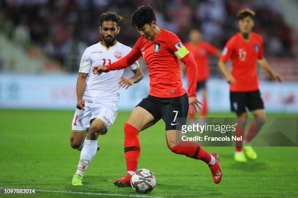 Son Heung-Min of South Korea takes on Ali Madan of Bahrain during the AFC Asian Cup round of 16 match between South Korea and Bahrain at Rashid...