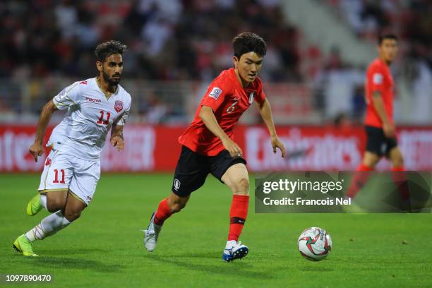 Hwang In-Beom of South Korea is chased by Ali Madan of Bahrain during the AFC Asian Cup round of 16 match between South Korea and Bahrain at Rashid...