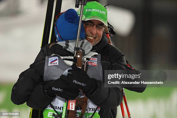 Uwe Muessiggang, head coach of Germany hugs Magdalena Neuner of Germany at the medal ceremony of the women's 7,5km sprint during the IBU Biathlon...