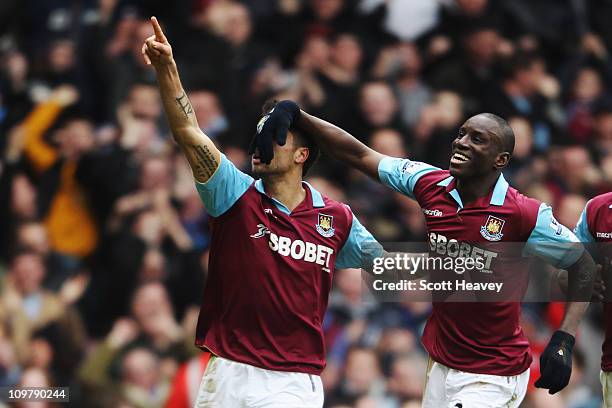 Manuel da Costa of West Ham United celebrates with team mate Demba Ba after scoring during the Barclays Premier League match between West Ham United...