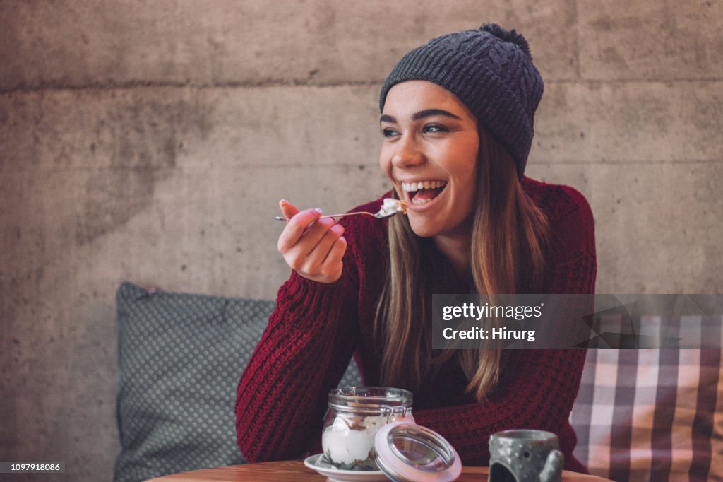 Happy woman eating healthy sweet snack