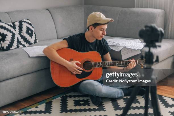 young vlogger, guitarist filming his vlogg - stars and strings 2019 stock pictures, royalty-free photos & images