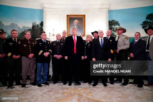 President Donald Trump speaks during a meeting with sheriff's from around the country as US Vice President Mike Pence looks on in the Diplomatic...
