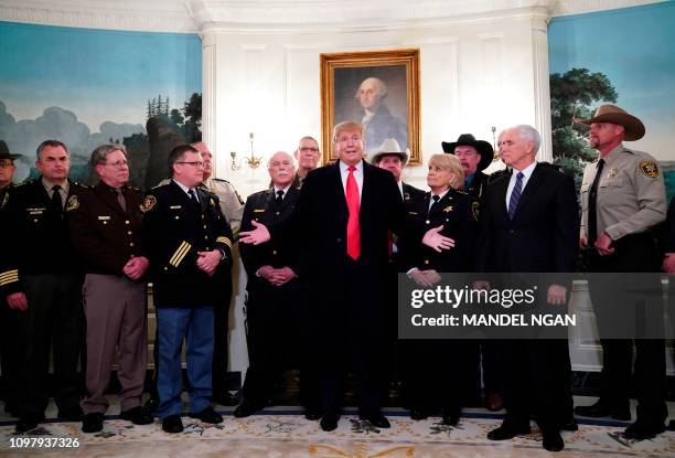 President Donald Trump speaks during a meeting with sheriff's from around the country as US Vice President Mike Pence looks on in the Diplomatic...