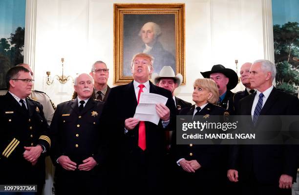 President Donald Trump speaks during a meeting with sheriff's from around the country as US Vice President Mike Pence looks on in the Diplomatic...