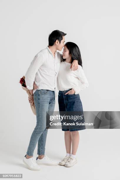 couple embracing in studio - studio kiss stock pictures, royalty-free photos & images