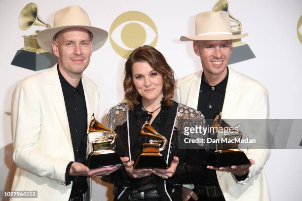 Tim Hanseroth, Phil Hanseroth and Brandi Carlile pose in the press room with the awards for Best American Roots Song for 'The Joke,' Best Americana...