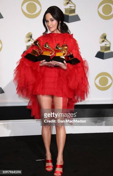 Kacey Musgraves poses in the press room with her awards for Best Country Solo Performance for 'Butterflies,' Best Country Song for 'Space Cowboy,'...