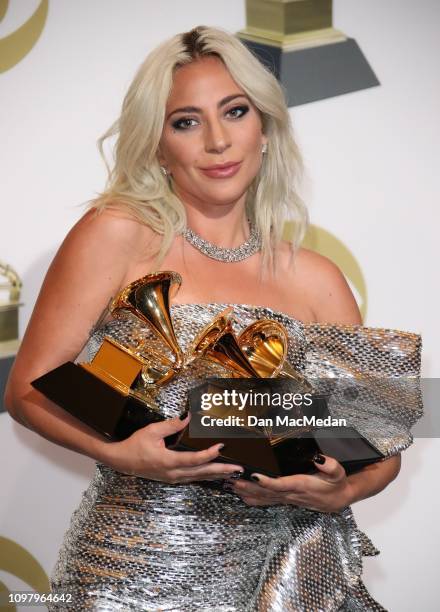 Lady Gaga poses in the press room with her awards for Best Song Written for Visual Media for 'Shallow,' Best Pop Duo Group Performance with Bradley...