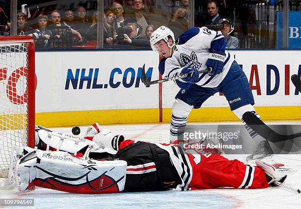 Tyler Bozak of the Toronto Maple Leafs gets stopped by Corey Crawford of the Chicago Blackhawks during game action at the Air Canada Centre March 5,...