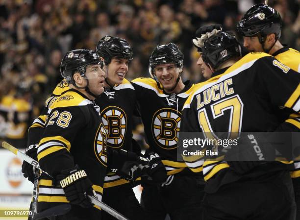 David Krejci of the Boston Bruins is congratulated by teammates Mark Recchi,Nathan Horton,Milan Lucic and Zdeno Chara after Krejci scored a goal in...