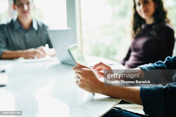 detail view of businesswoman working on digital tablet during meeting in conference room - room service stockfoto's en -beelden