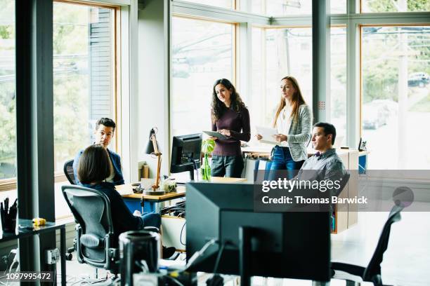 creative team having project meeting at workstation in creative studio - indian startup stock pictures, royalty-free photos & images