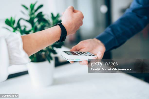 contactless paying with smartwatch - rfid technology stock pictures, royalty-free photos & images