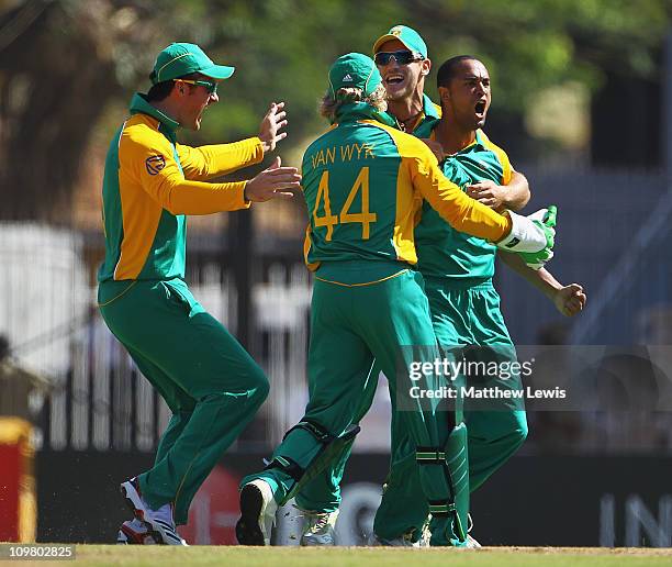 Robin Peterson of South Africa is congratulated by team mates, after Kevin Pietersen of England was caught by Jacques Kallis during the 2011 ICC...