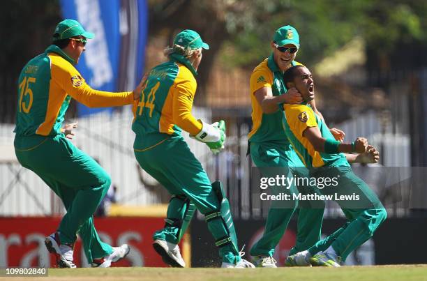 Robin Peterson of South Africa is congratulated by team mates, after Kevin Pietersen of England was caught by Jacques Kallis during the 2011 ICC...