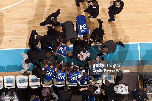 An overhead view of the Duke Blue Devils and head coach Mike Krzyzewski in a huddle during a media timeout versus the North Carolina Tar Heels on...