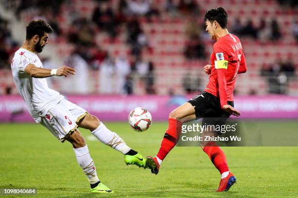 Son Heungmin of South Korea competes with Waleed Mohamed Alhayam of Bahrain during the AFC Asian Cup round of 16 match between South Korea and...